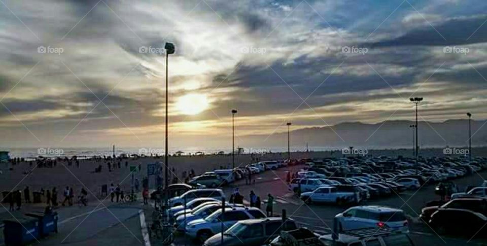 Cars, people and sunset