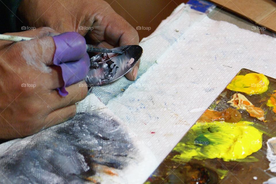 A person painting with paintbrush