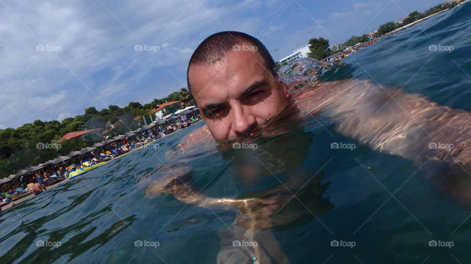 man on the surface of the sea