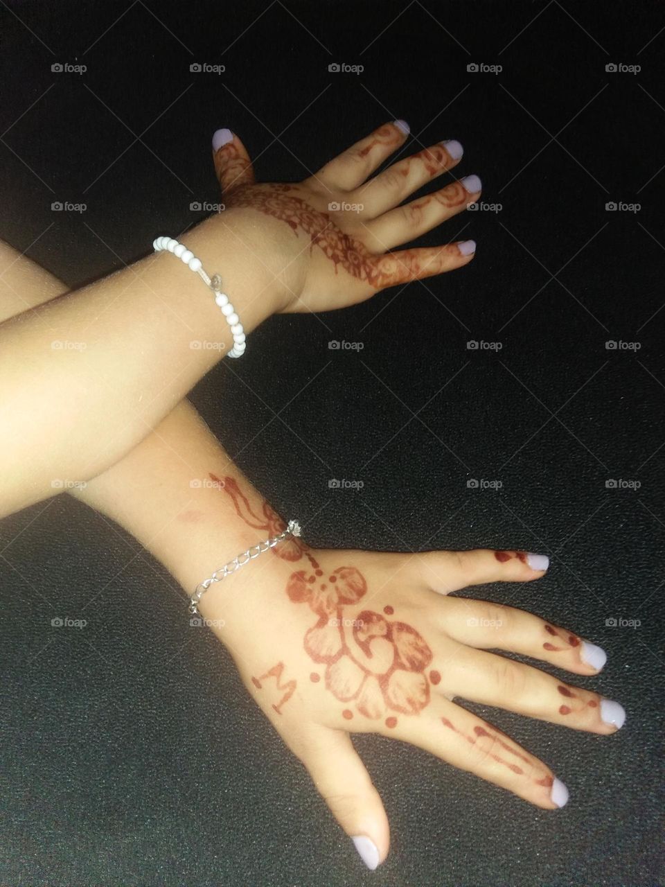 Two beautiful hands decorated by henna.