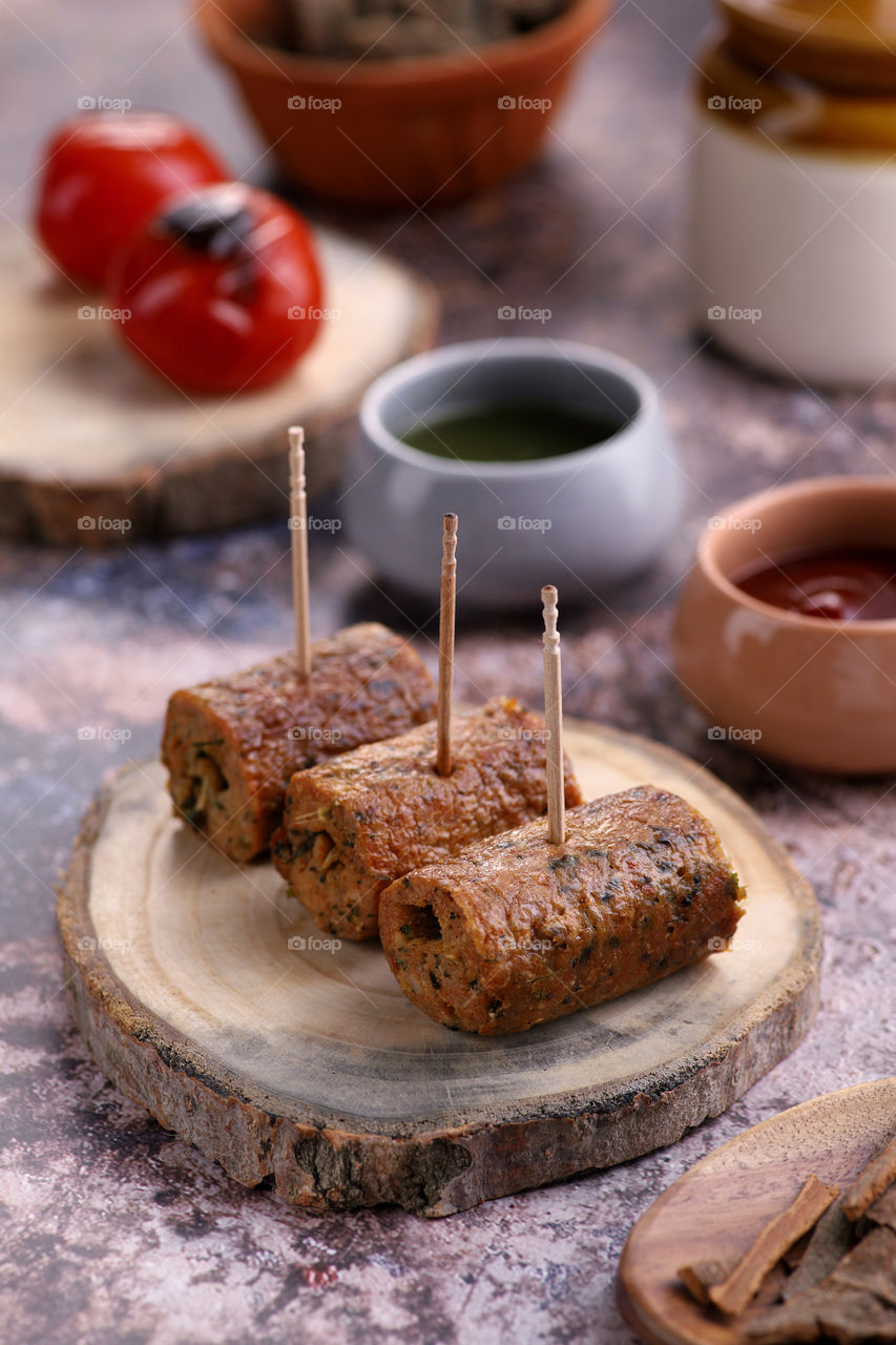 Indian food - chicken kebab on a wooden platter