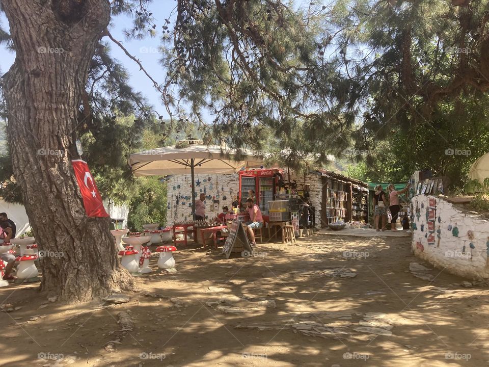 Greek village in Turkey. Blue sky and tall palm trees. Sunsets and sunny days. Summertime in Kusadasi. Vacation travel in Turkey . Summer view. Sunny day during vacation 