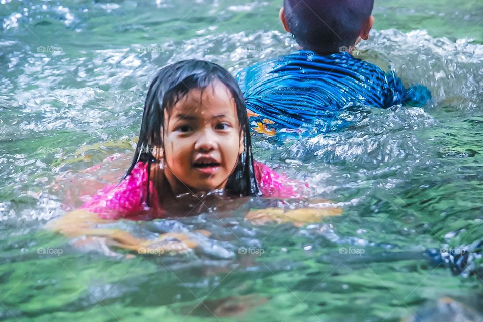 Girl playing in Kao Yai Waterfall ,Thailand