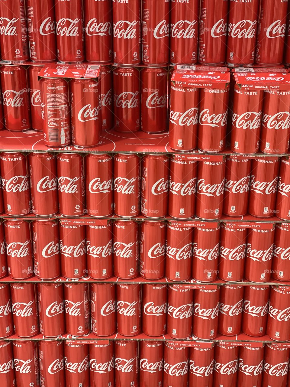 Coca Cola tin cans at the supermarket