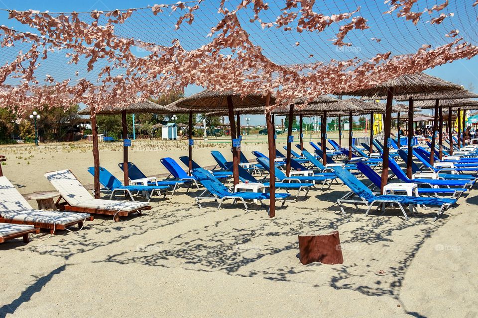 Deck chairs and umbrellas at the beach in Greece