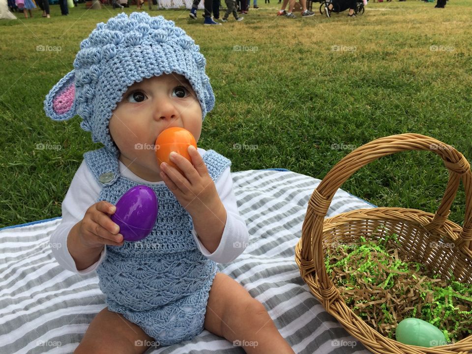 Baby’s first Easter with eggs and basket