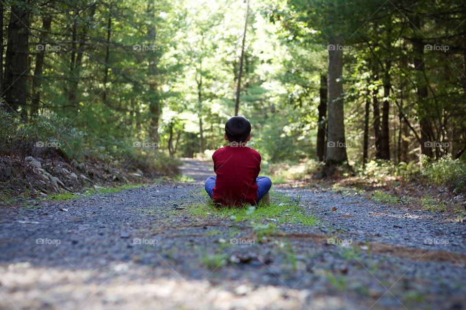 My Woodland Boy; Young Boy in red shirt sitting in the middle of an old gravel road in the middle of the wood