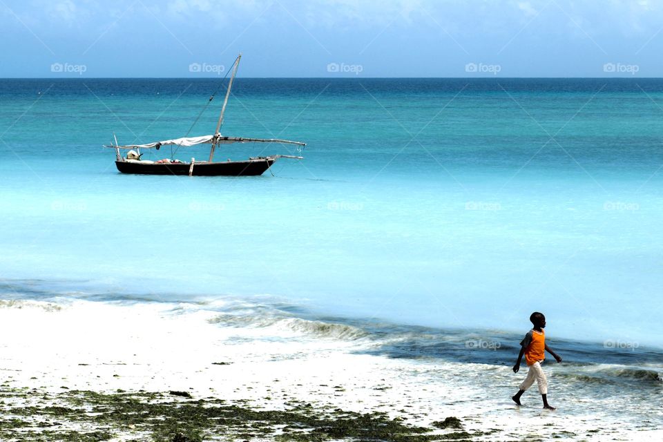 Zanzibar Island. Cute boy walking on Nungwi Beach, Zanzibar
