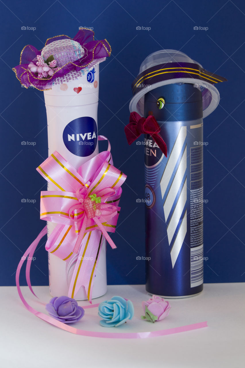 Nivea's  two deodorants are hats with painted faces and eyes . Symbol of a couple in love for Valentine's Day February 14