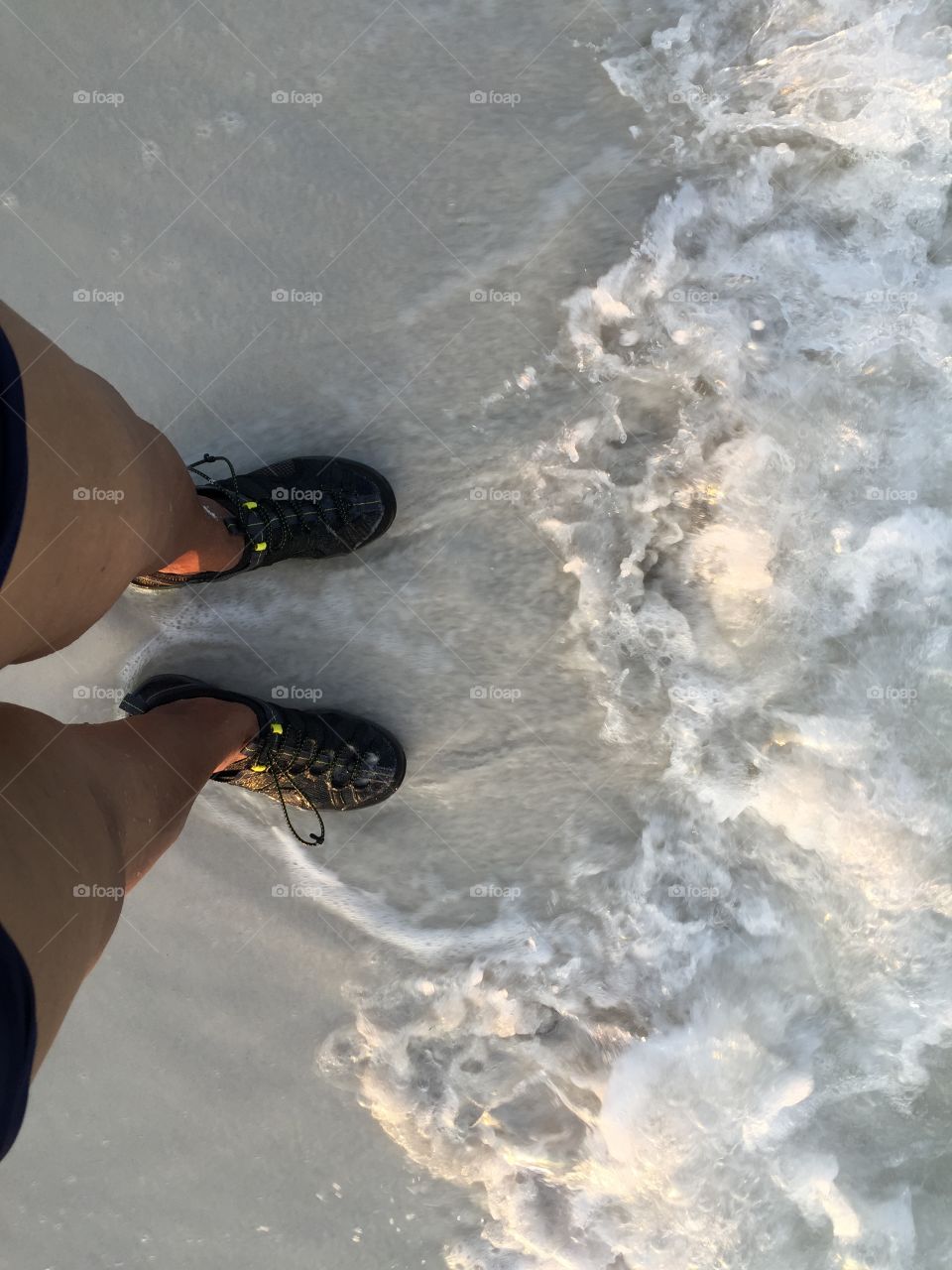 Looking at my feet while the waves come and go.