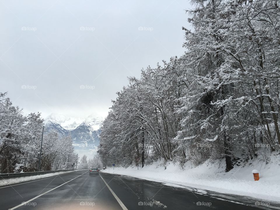 winter road in the forest and mountain 