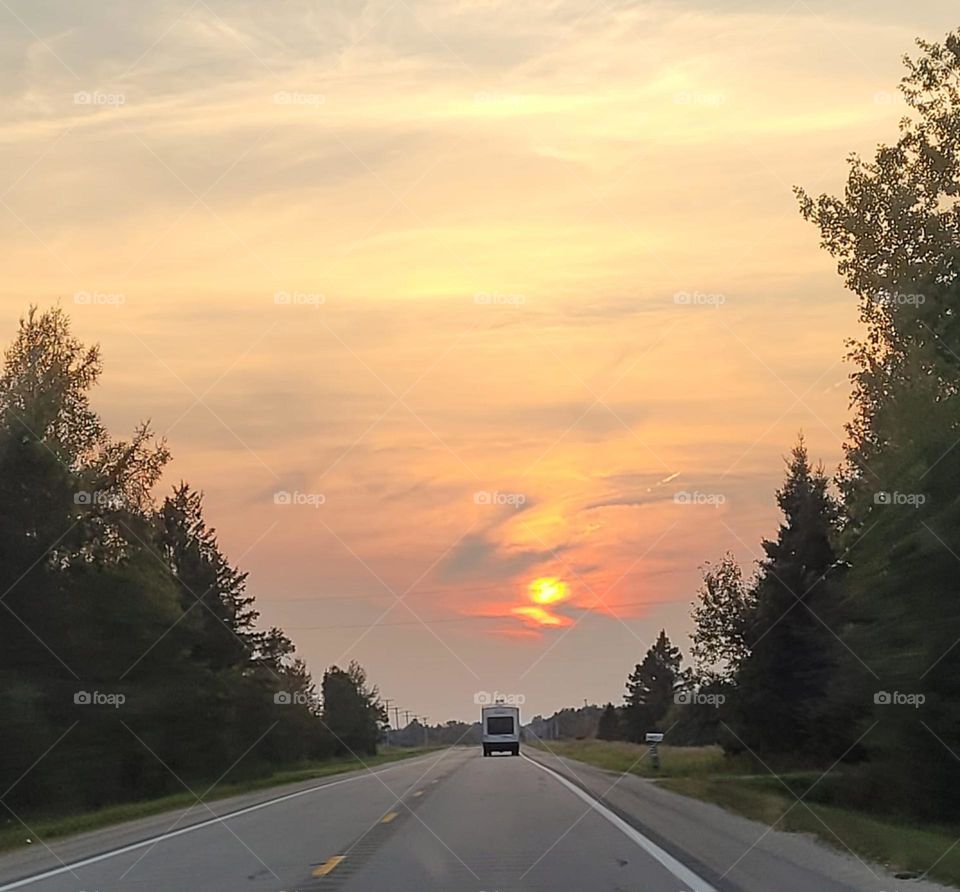 Fire sunset with road and trees 