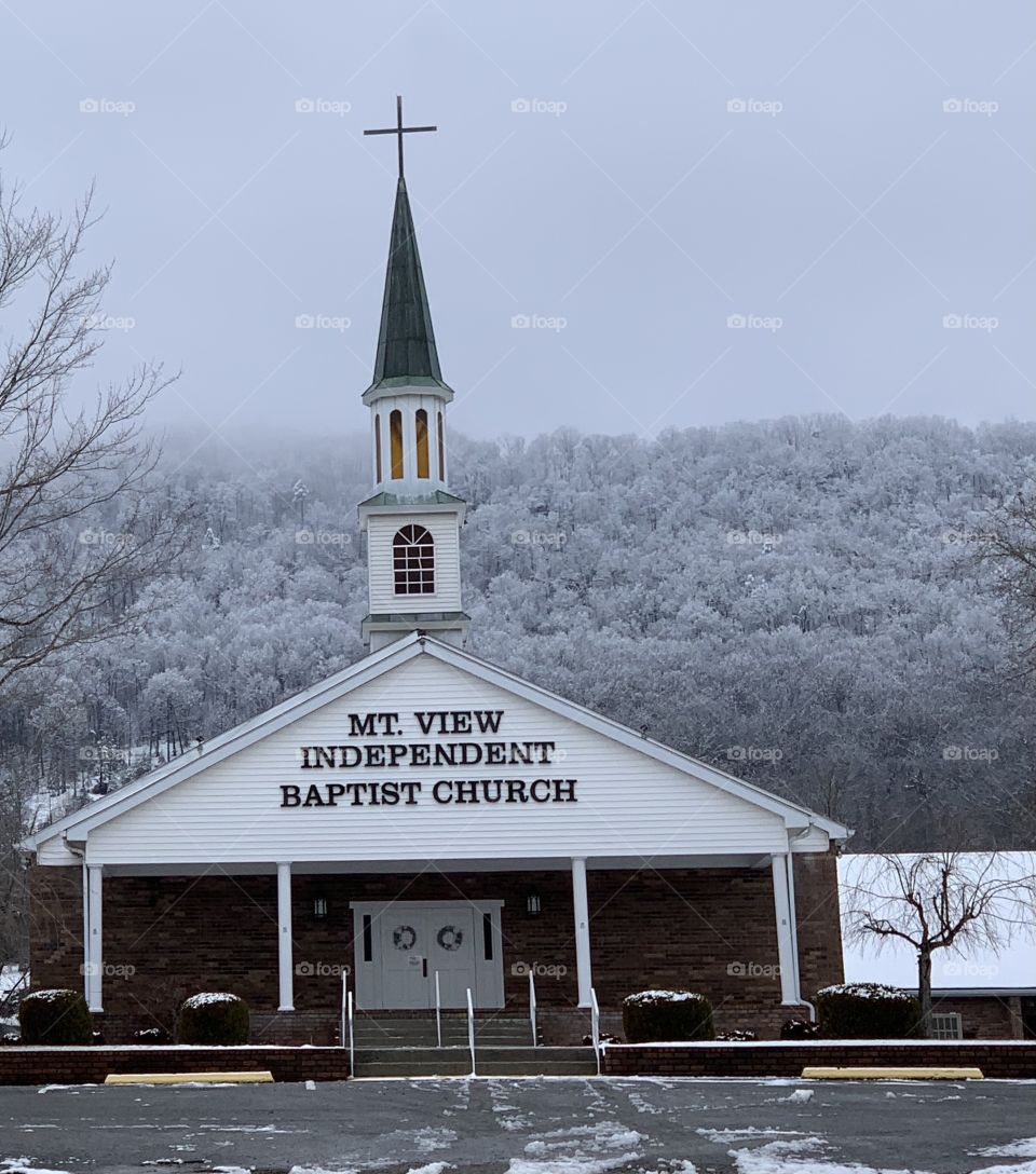 Snowy church in the mountains 