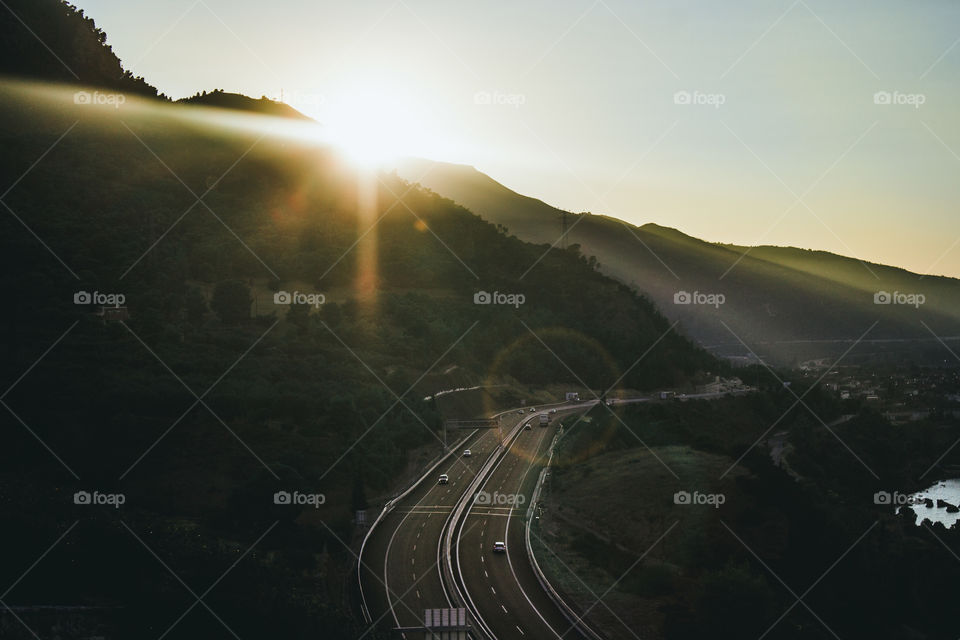 hightway between forest at the sunset