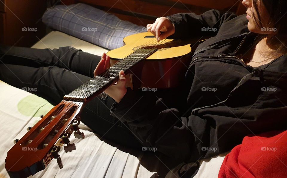 A moment in our personal space, playing the guitar, a very beautiful musical instrument and a spectacular sound