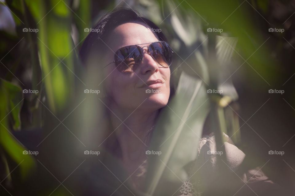 Up close portrait of a woman in corn field