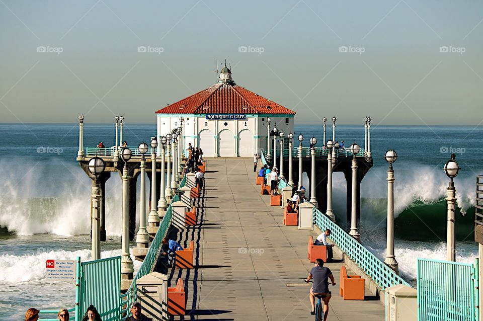 Big waves surround Manhattan Beach Pier, CA.