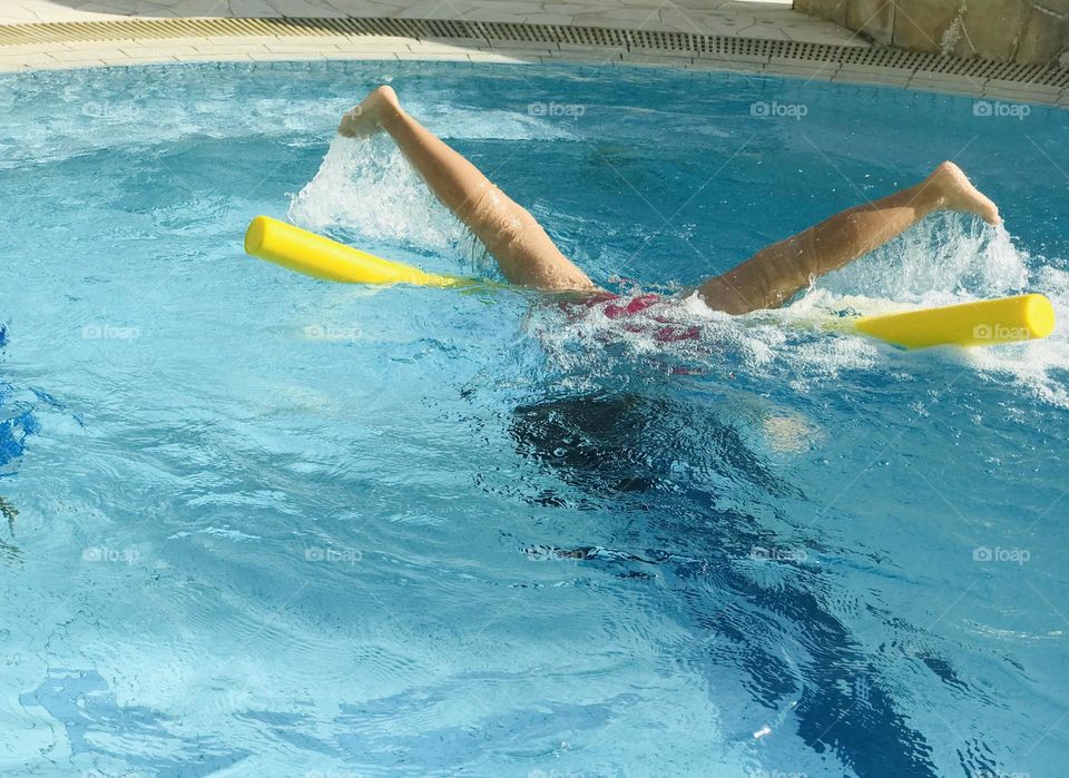 A girl having a lot of fun at outdoor swimming pool ‘and she’s enjoying like anything in summertime,she put her legs up,head down to the pool 🏊‍♀️