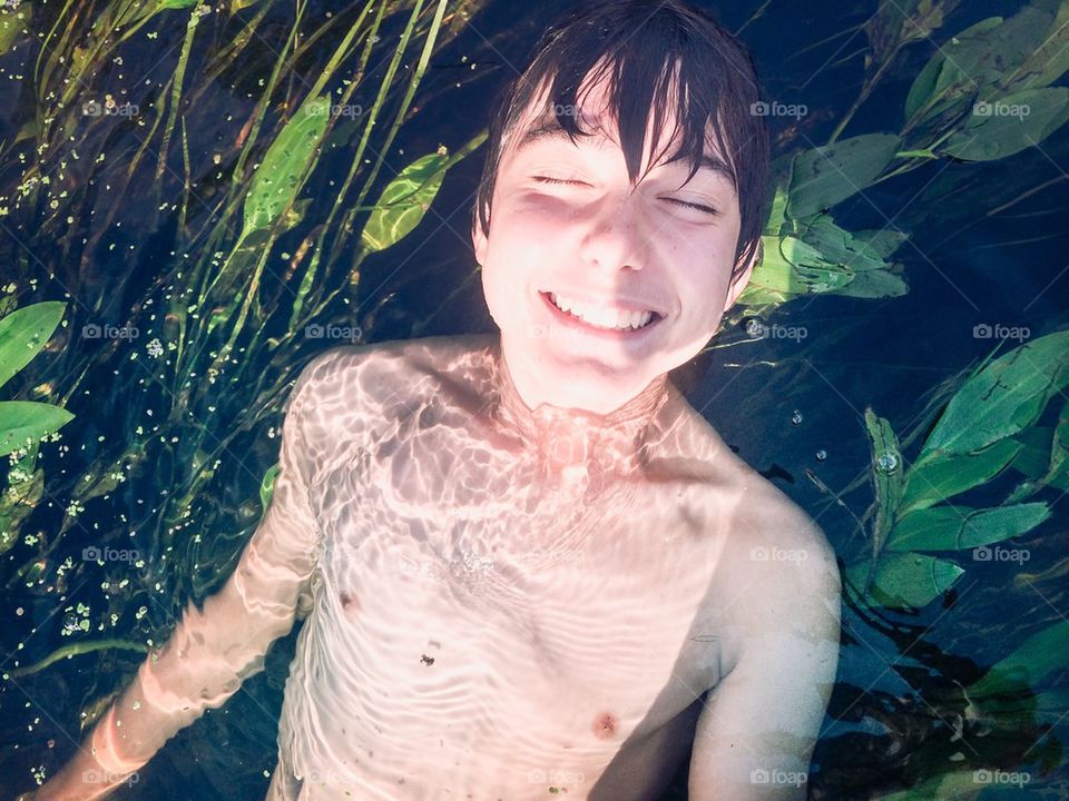 Boy submerged in a river