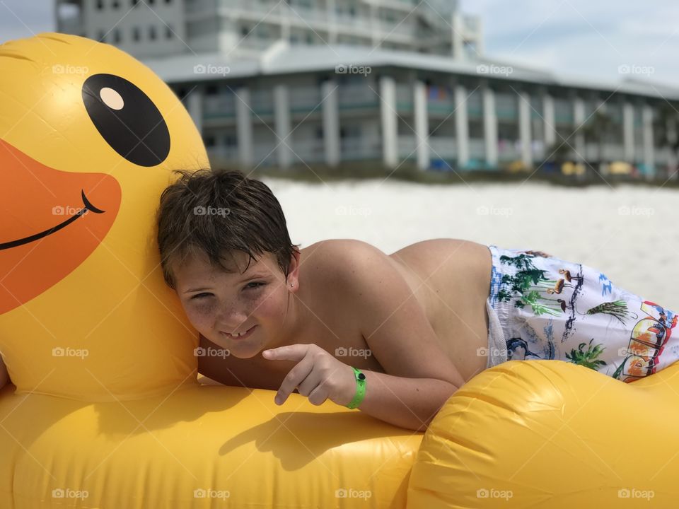 Child with Rubber ducky beach float