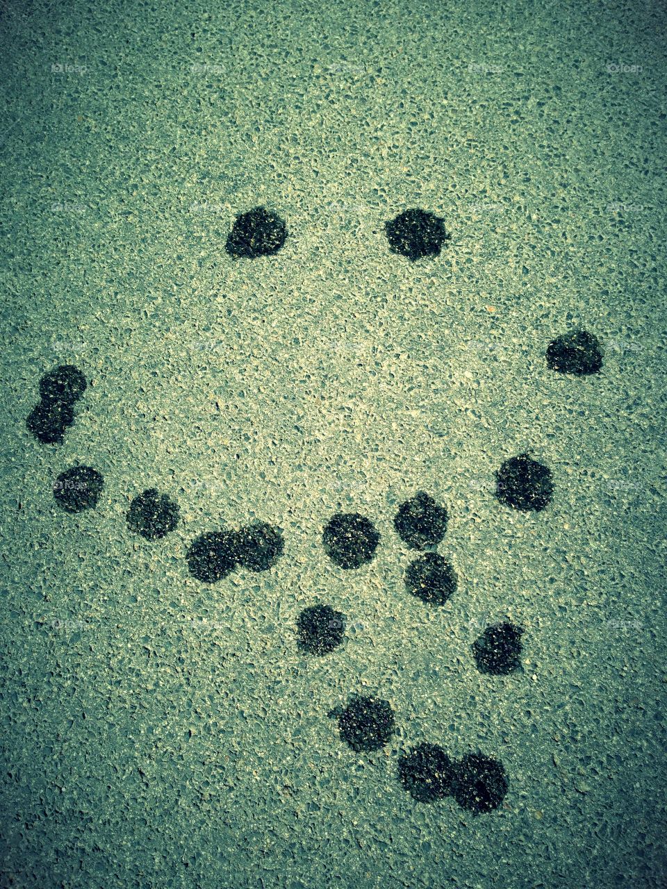 Street smile. Smile made with a wet Tennisball. Dropping on ground 