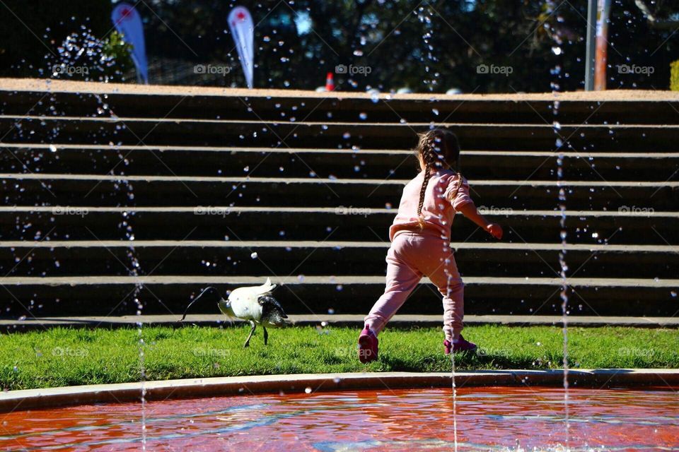 A Baby girl was running around the park