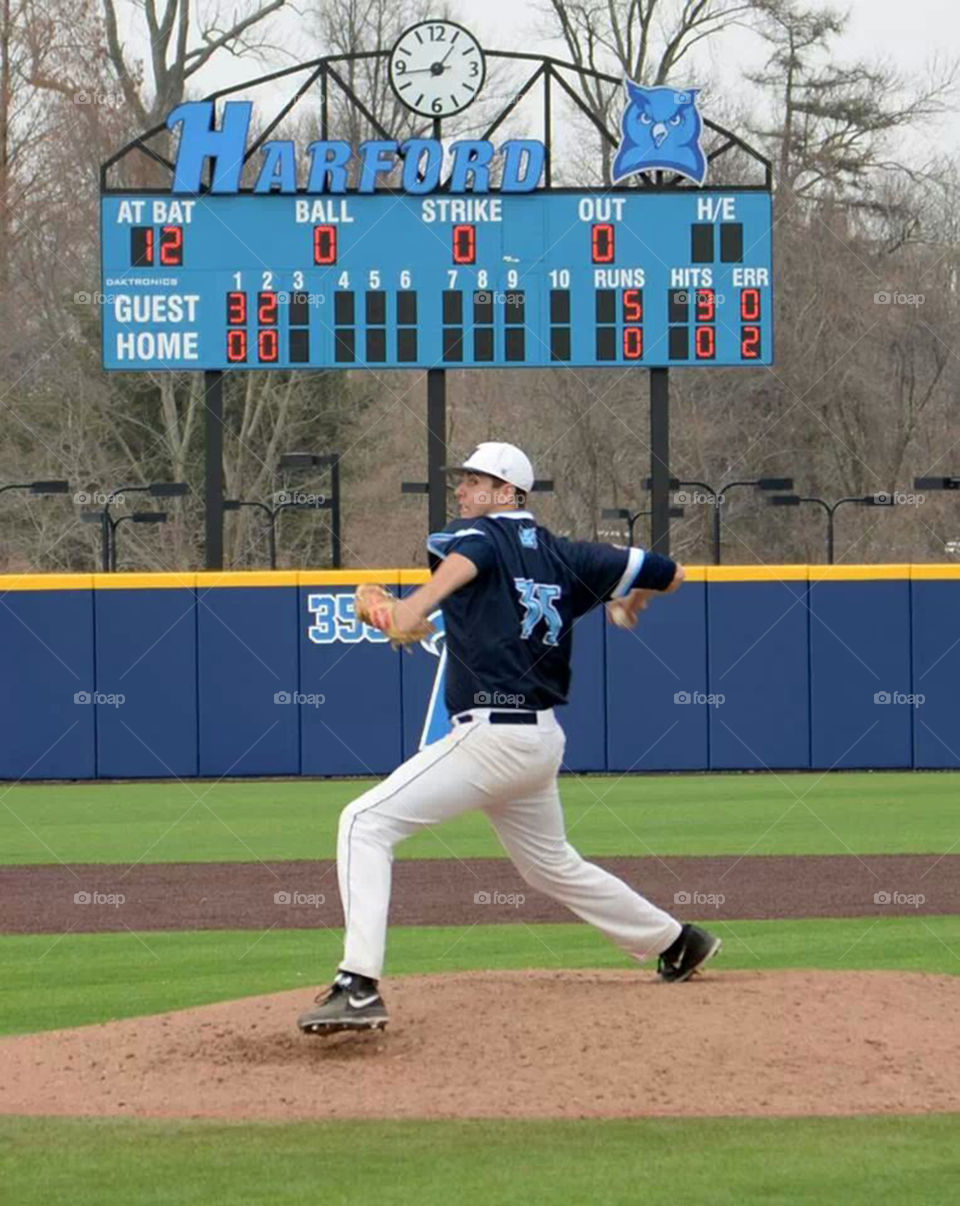 baseball pitcher. 6' 8" pitcher takes the mound in college game