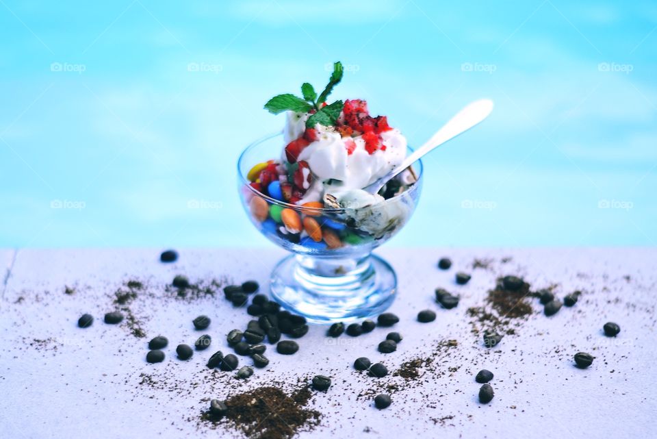 Ice cream bowl with candy and strawberry slice