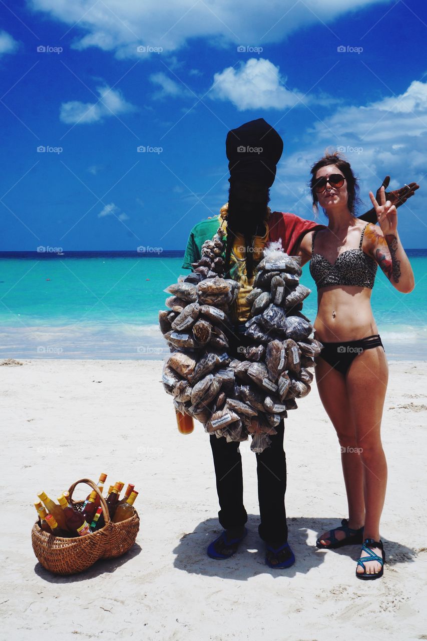 Woman posing with man carrying dried herbs