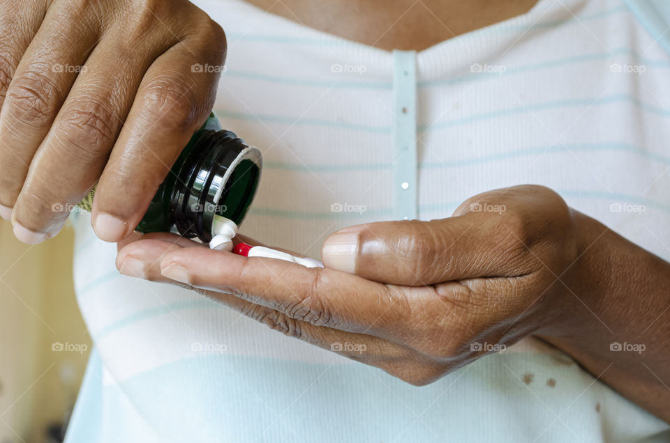 Pouring Out Tablets From Bottle