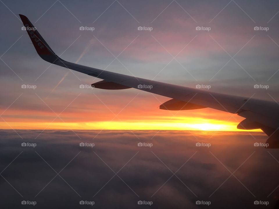 Sun rising above the clouds en route to Malta