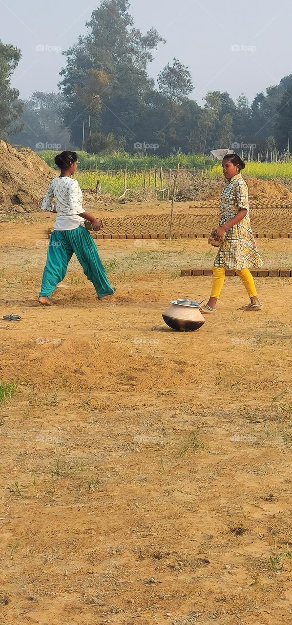 Girls working on a brick feild