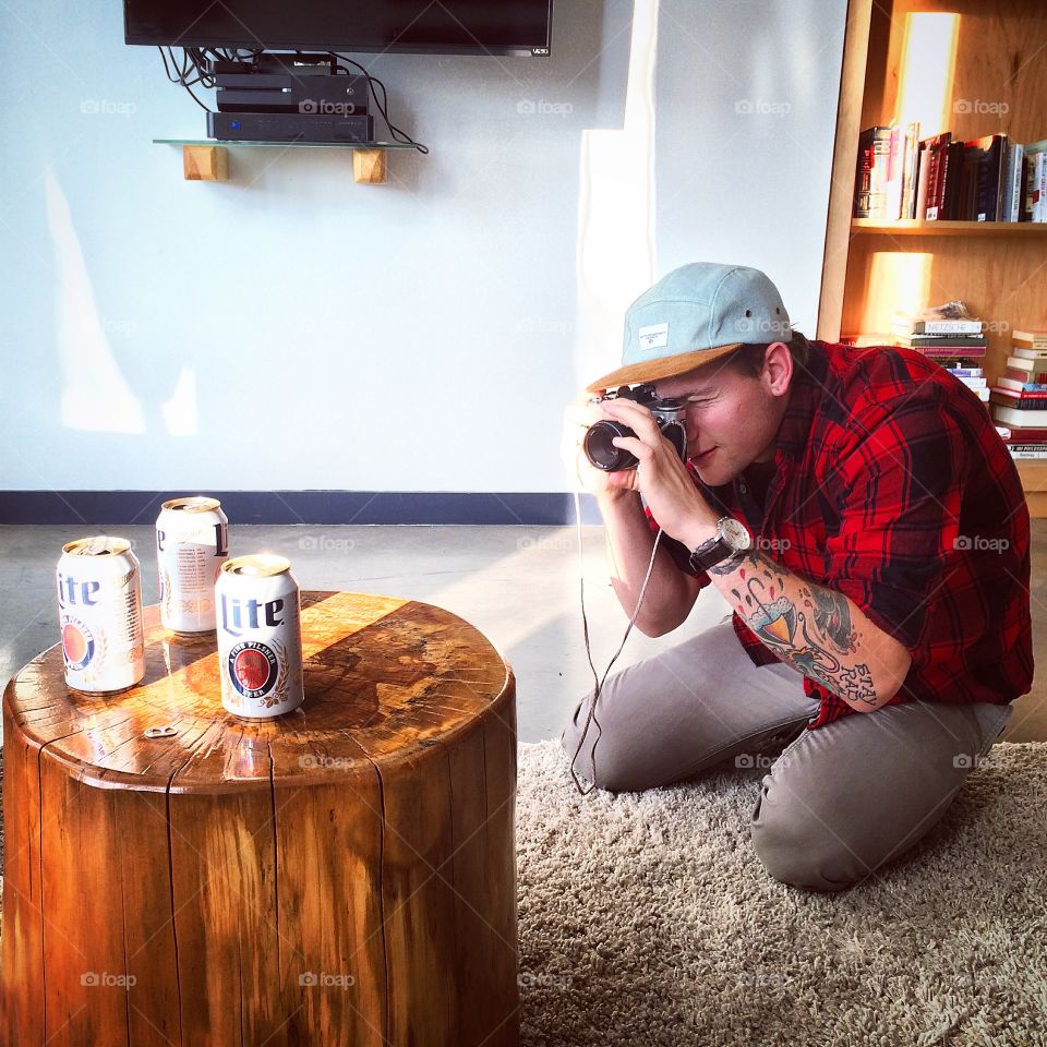 Hipster photography. this photo is of my roommate taking a hip picture of some beer cans.