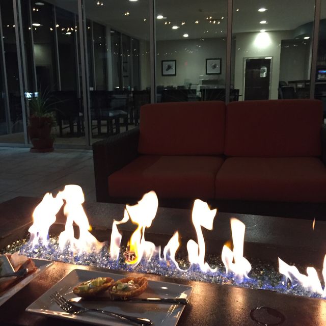 glass rock fire pit outside hotel lounge