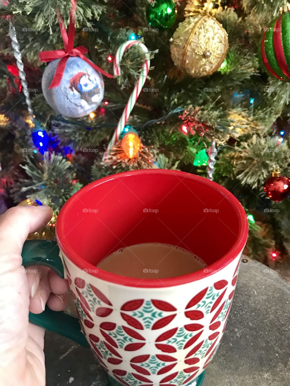 Hot cocoa in front of Christmas tree