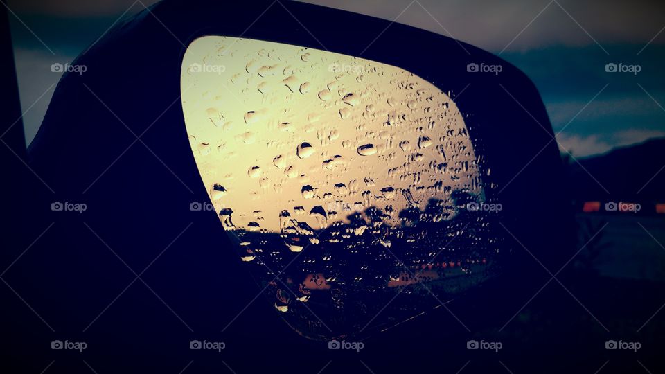 water droplets on mirror of car