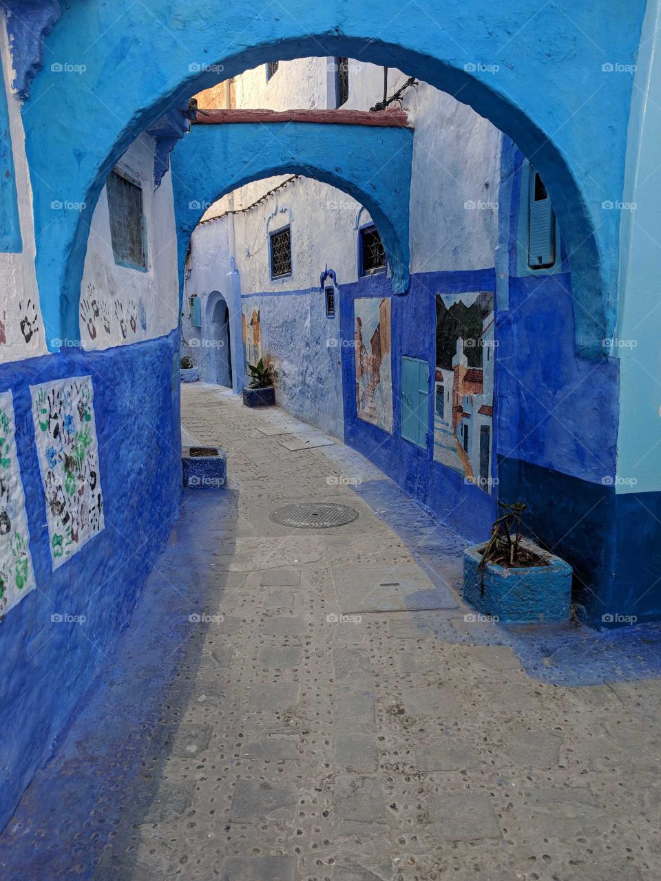 Blue Street/Alley in Chefchaouen (The Blue City), Morocco - An Arch with Lots of Art Lining the Walls