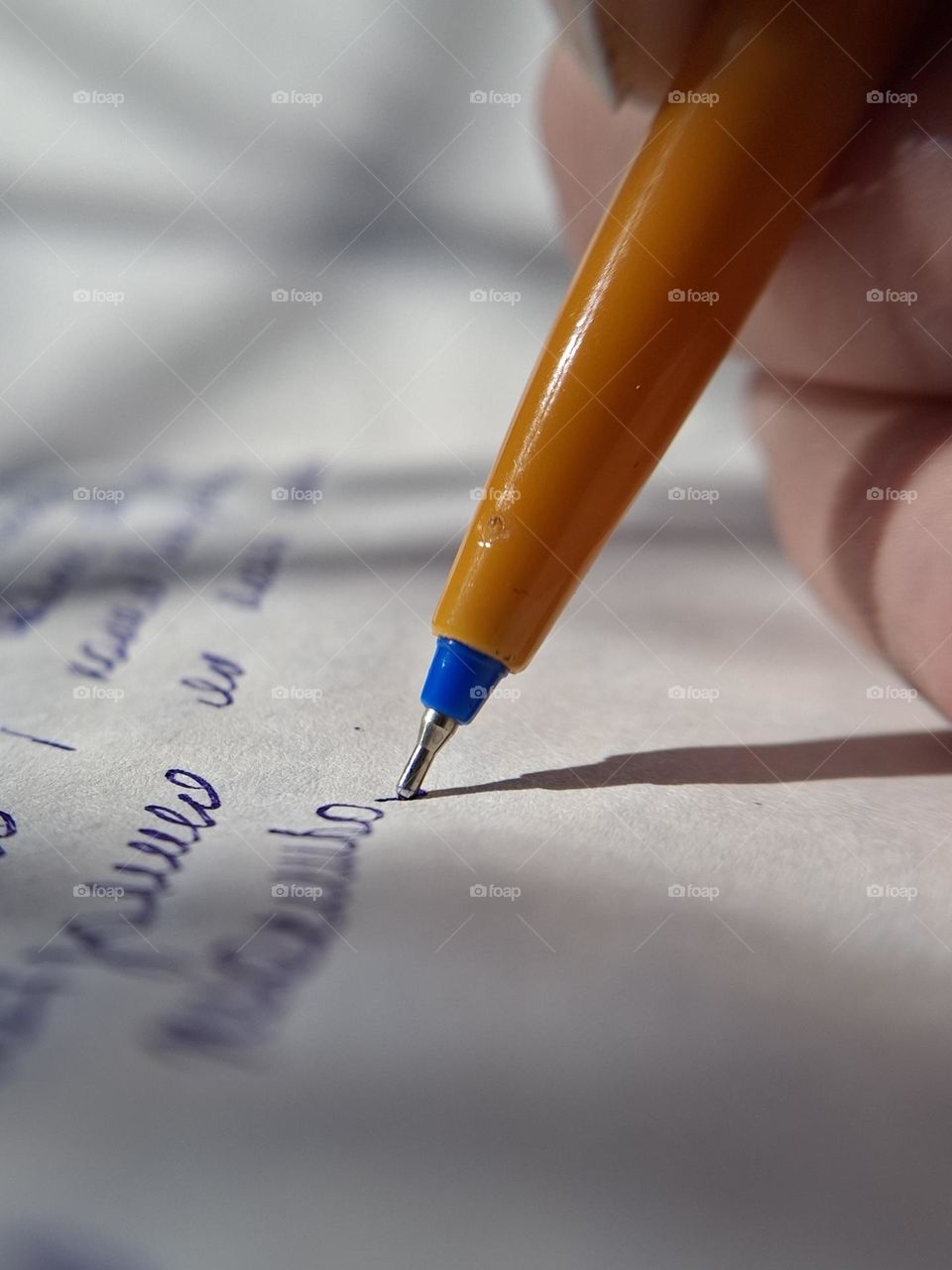 Close-up view of a pen tip gliding on paper, emphasizing the vibrant interplay of complementary colors and the beauty of everyday objects