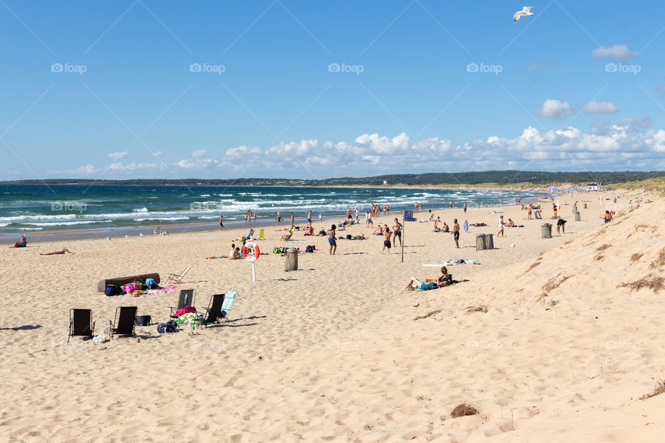 People enjoying the beach on a sunny day 