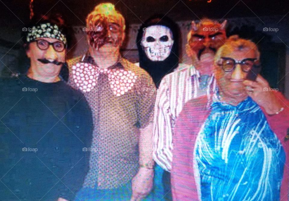Family dressed in costumes for Halloween creepy portrait! Masks on peoples faces!