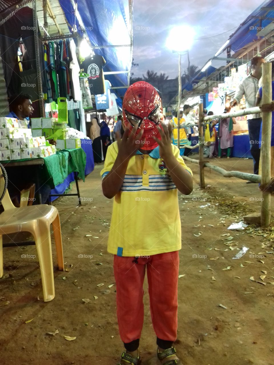 kid enjoying with use spiderman mask in exhibition