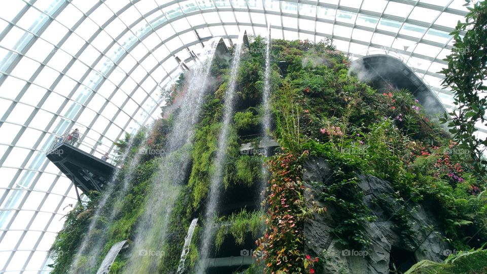 Amazing artificial waterfall inside a building. The joy of traveling.