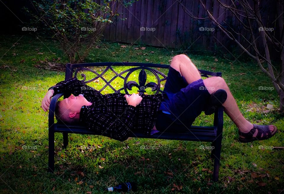 Man resting on bench in park