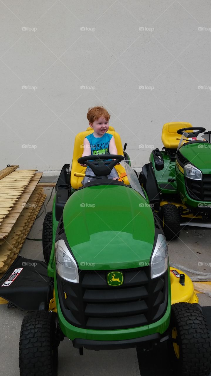 Little boy on a big tractor