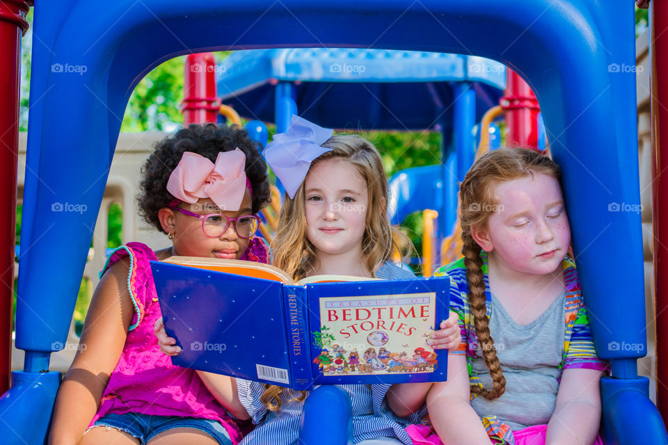 Three Girls Reading on the Playground 3