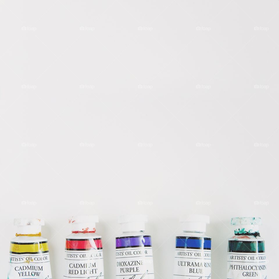 Artist supplies oil paint tubes on white background 