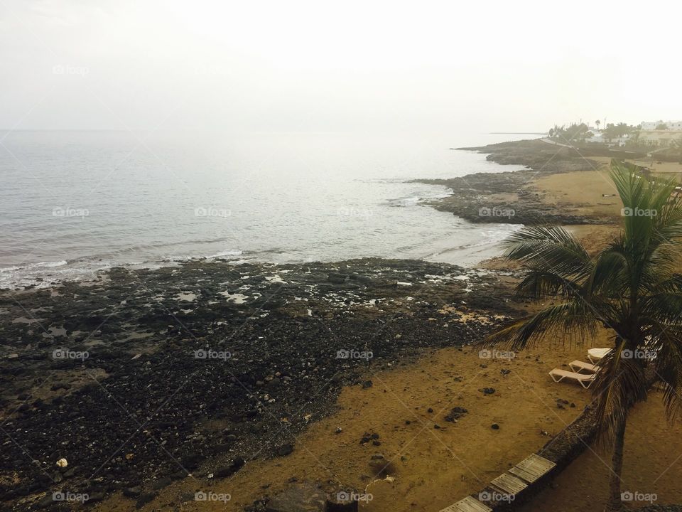 A cloudy morning in Costa Teguise, the fog should lift by noon, but for the time being the seafront is still as beautiful and as picturesque as ever.