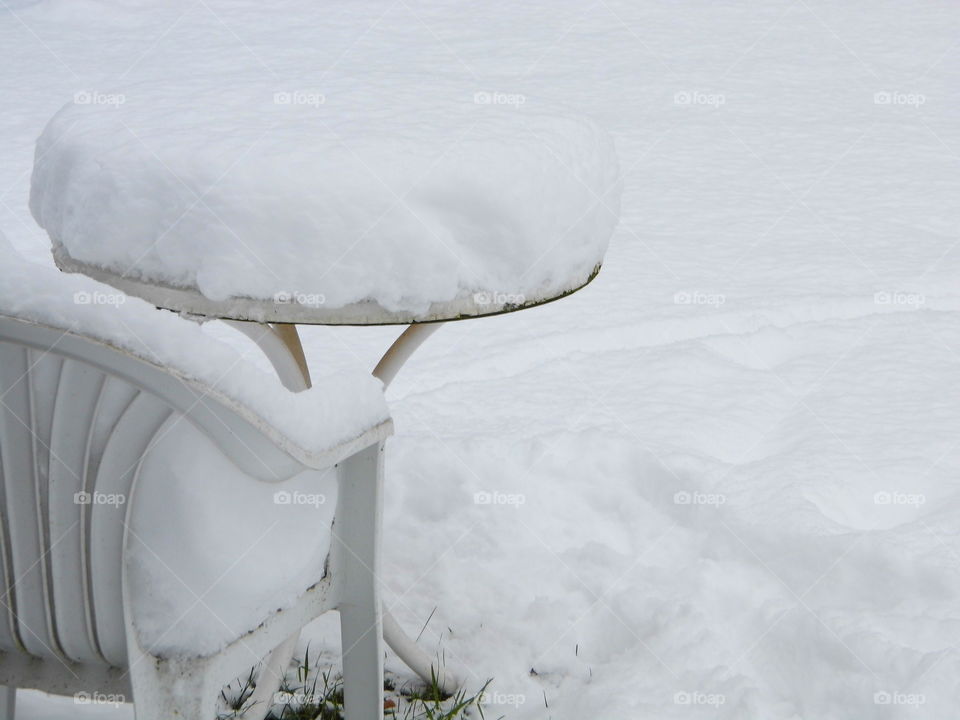 snow on the table in the garden