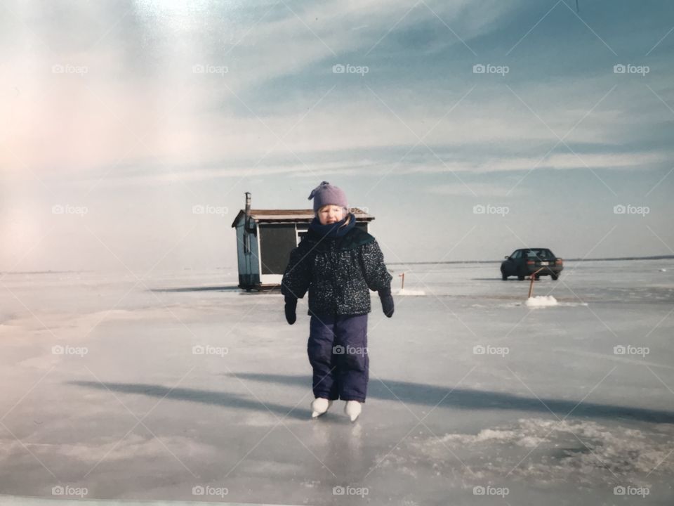Vintage kid picture ice skating in winter with cloudy sky