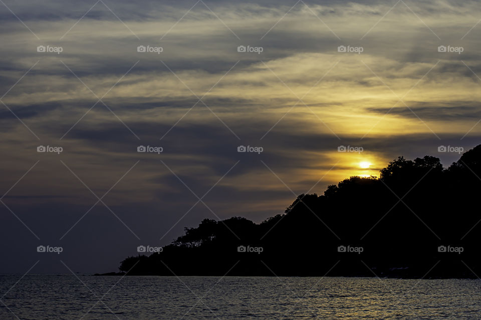 The sunset behind the island in the sea at Koh Kood, Trat in Thailand.